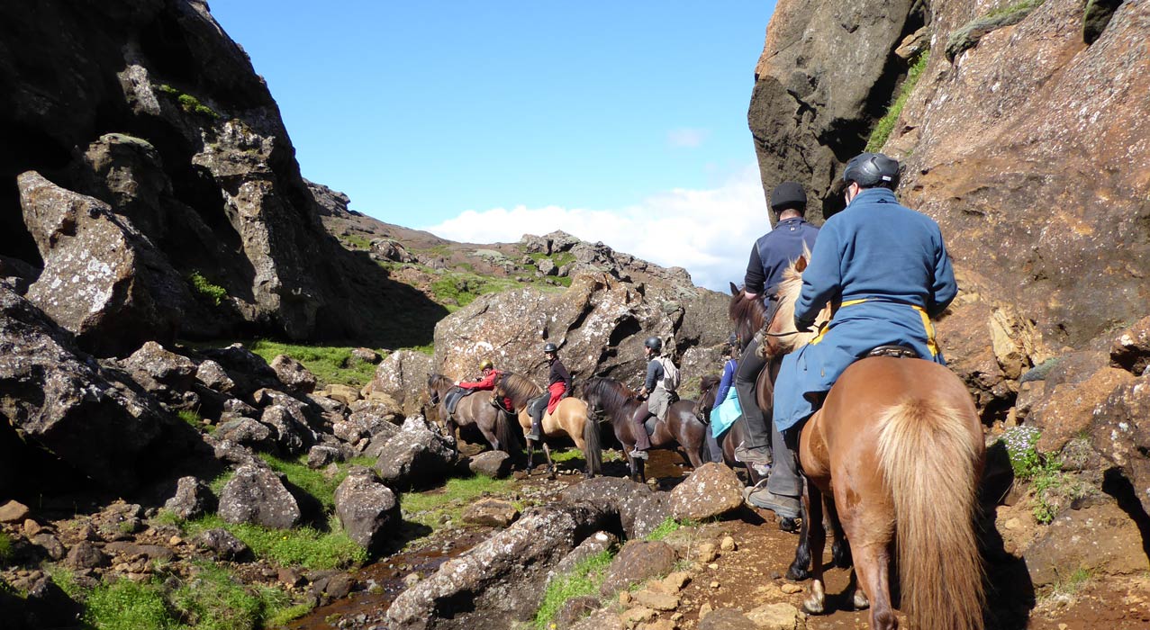 Reiter während einer Reittour in einem Canyon in Island